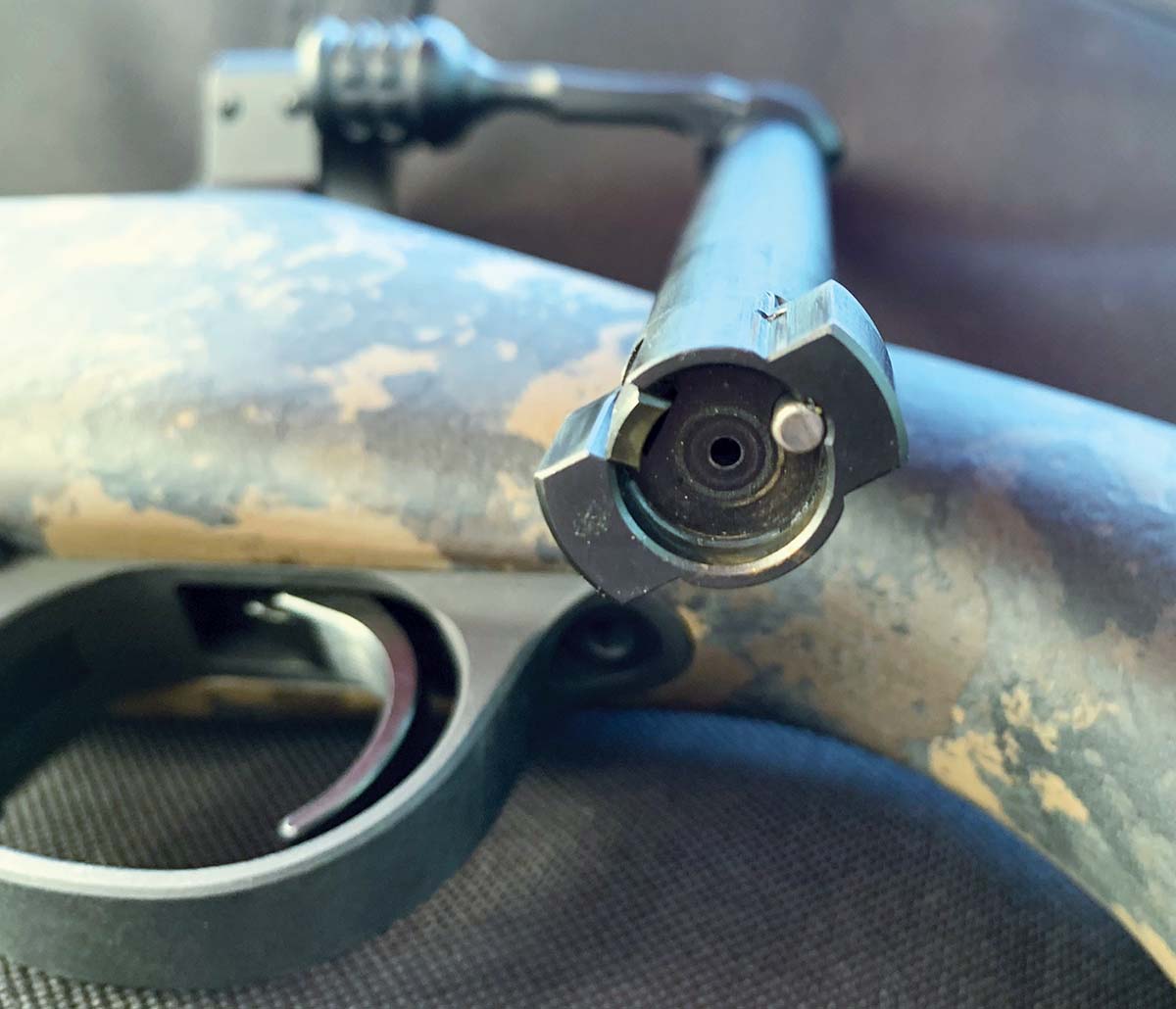 A bolt close-up shows the recessed spring-loaded extractor and ejector.